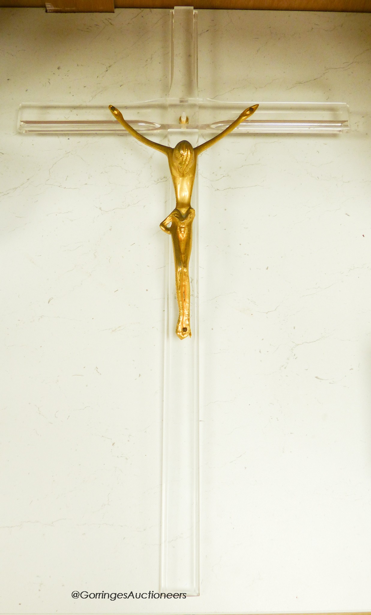 A gilt metal and perspex crucifix formerly attributed to Philip Stark, 58cm long